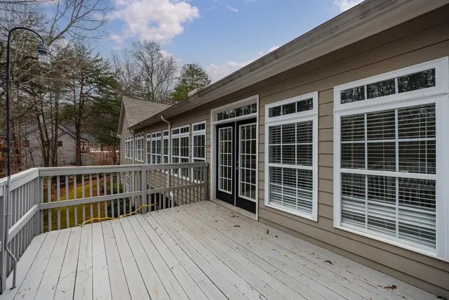 a view of a deck with wooden floor and fence