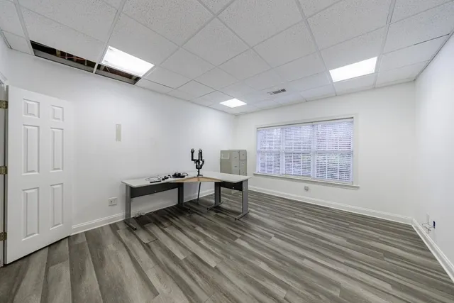 a view of a room with wooden floor and furniture