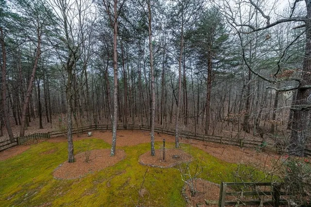 a backyard of a house with lawn chairs and wooden fence