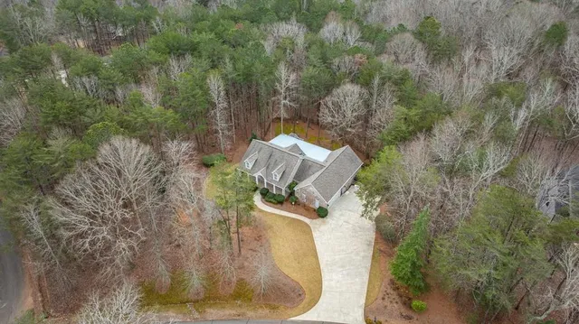 a view of swimming pool with a yard and lake view in back