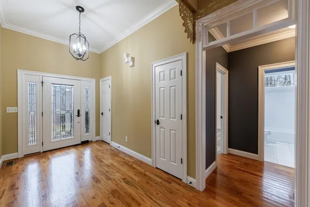 a view of an entryway with wooden floor