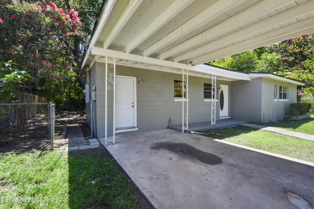 a view of a backyard with plants and a patio