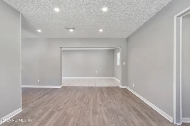 a view of wooden floor and windows in a room