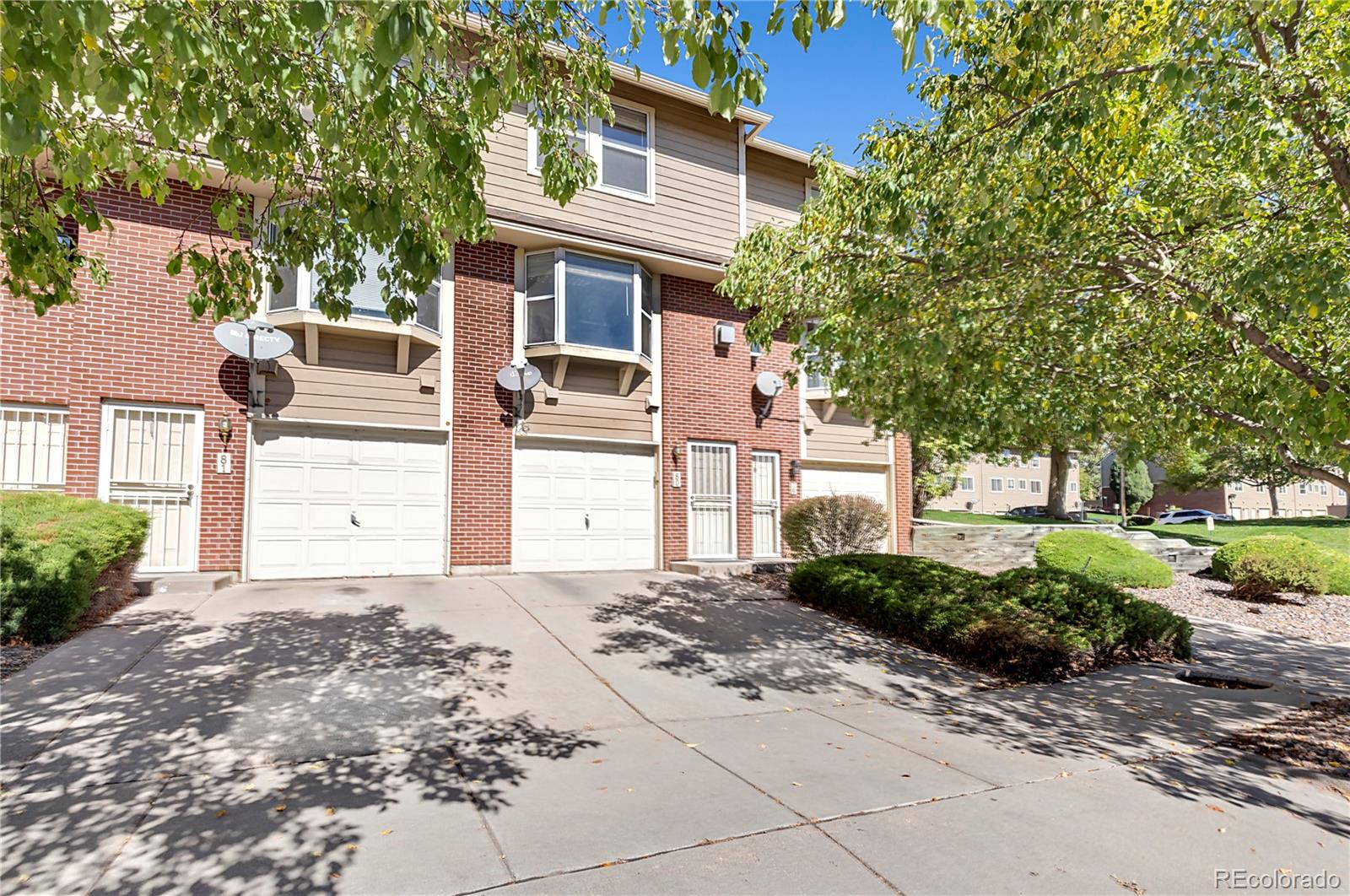 3300 West Florida Avenue, Unit 80 Denver, CO 80219 - Photo 1 of 24 a front view of a house with a yard and garage