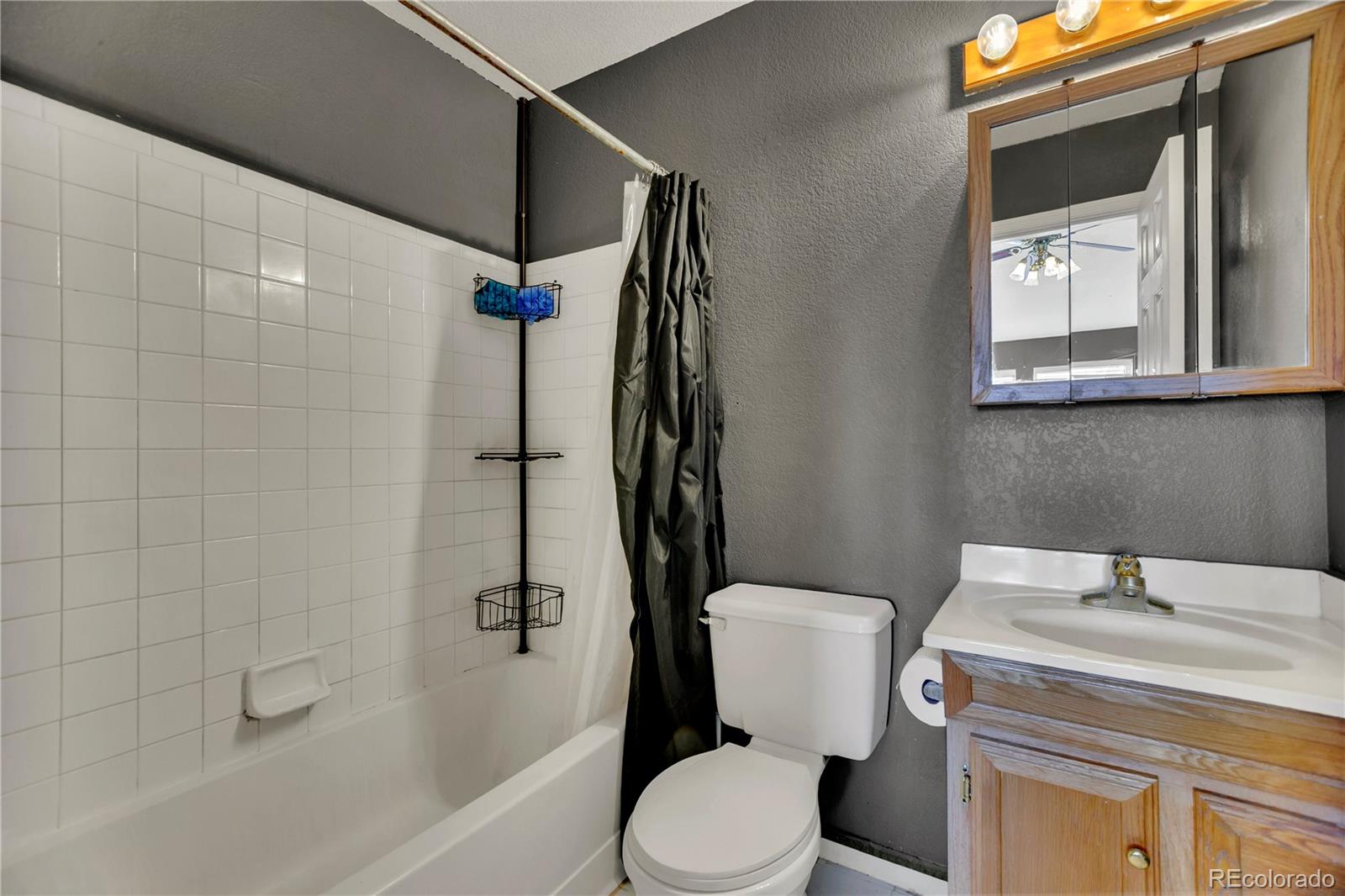 3300 West Florida Avenue, Unit 80 Denver, CO 80219 - Photo 12 of 24 a bathroom with a sink a toilet and shower