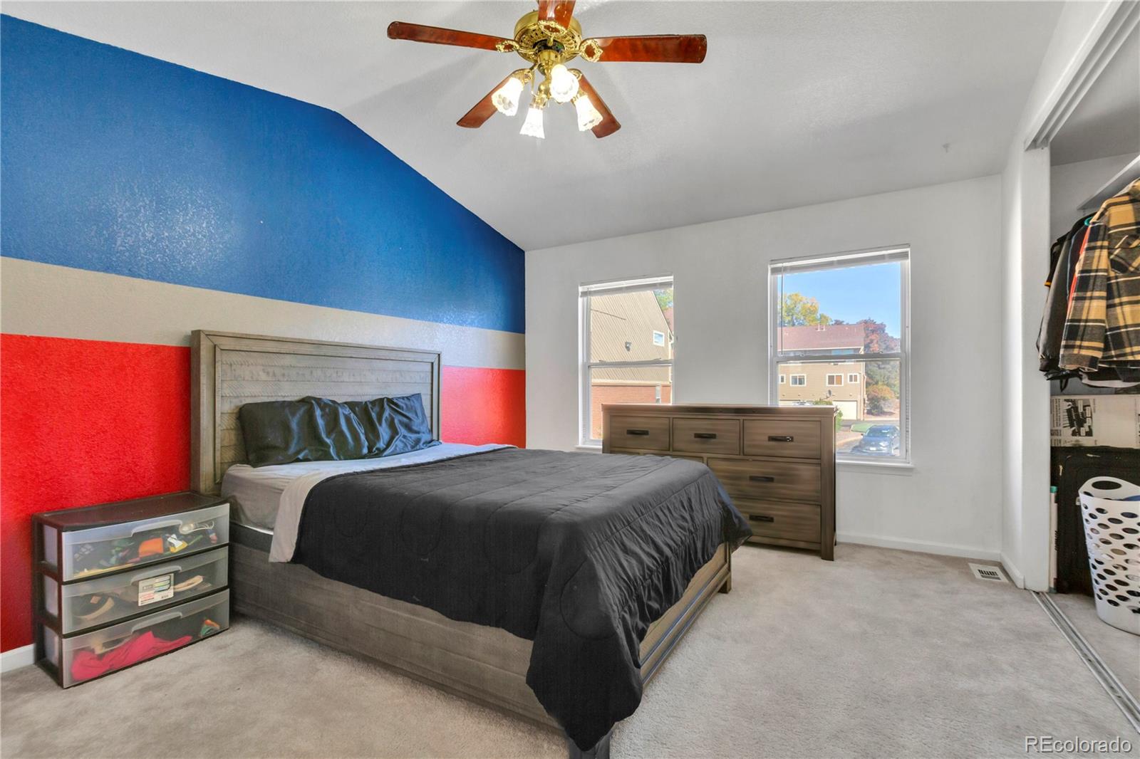 3300 West Florida Avenue, Unit 80 Denver, CO 80219 - Photo 14 of 24 a bedroom with a bed and a chandelier