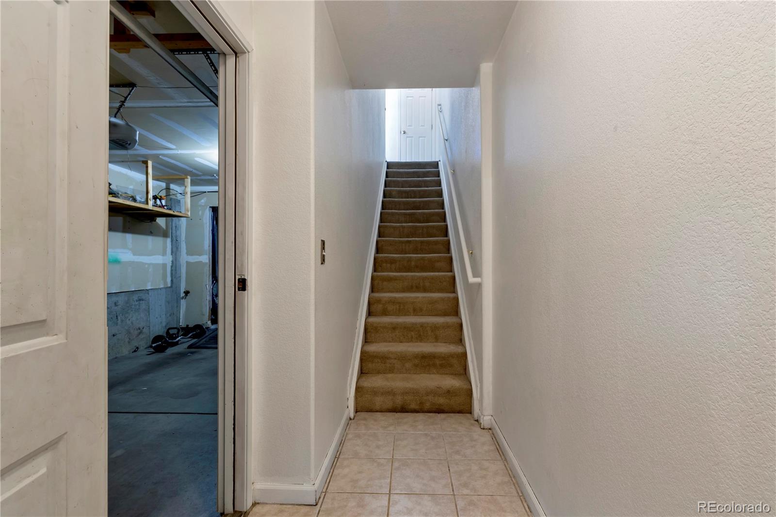 3300 West Florida Avenue, Unit 80 Denver, CO 80219 - Photo 19 of 24 a view of hallway with stairs and wooden floor