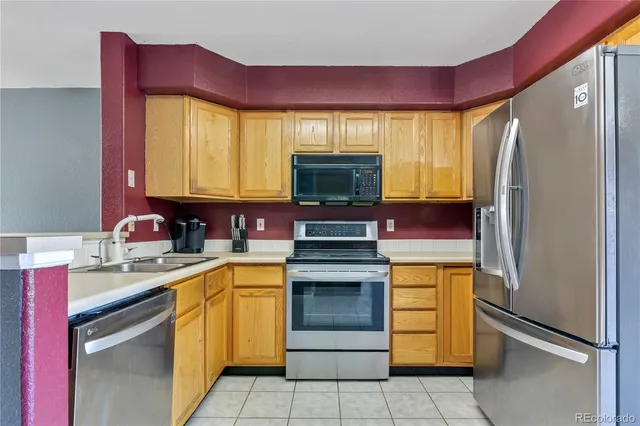 a kitchen with a sink appliances and cabinets
