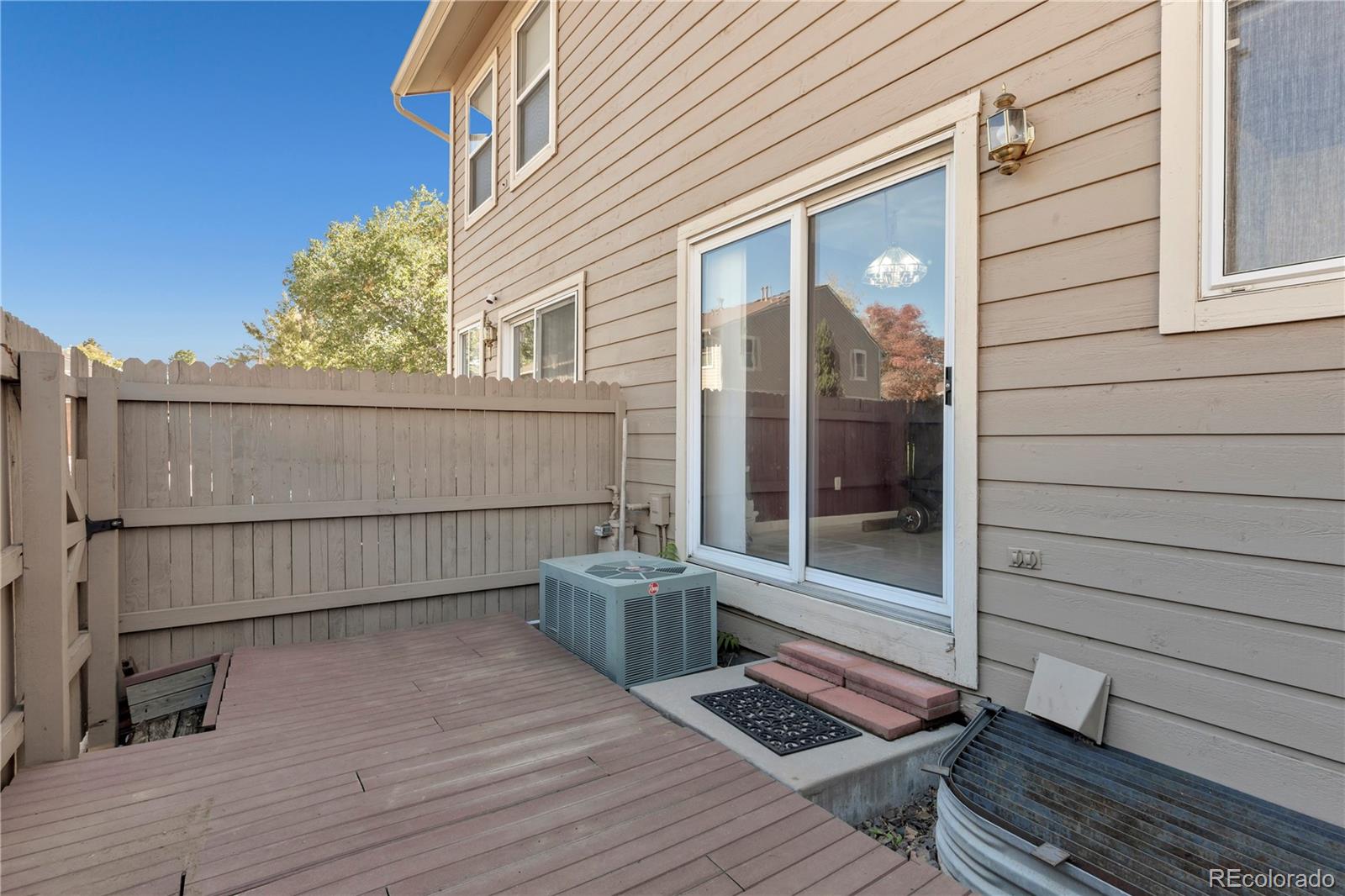 3300 West Florida Avenue, Unit 80 Denver, CO 80219 - Photo 23 of 24 a view of a balcony with wooden floor and fence