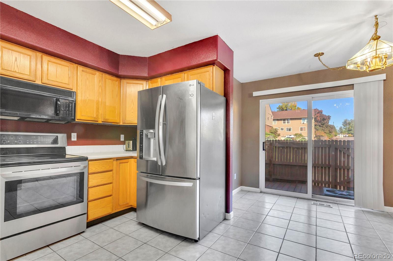 3300 West Florida Avenue, Unit 80 Denver, CO 80219 - Photo 3 of 24 a kitchen with a refrigerator and a stove
