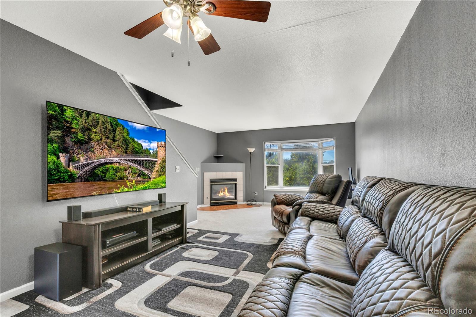 3300 West Florida Avenue, Unit 80 Denver, CO 80219 - Photo 6 of 24 a living room with furniture and a flat screen tv