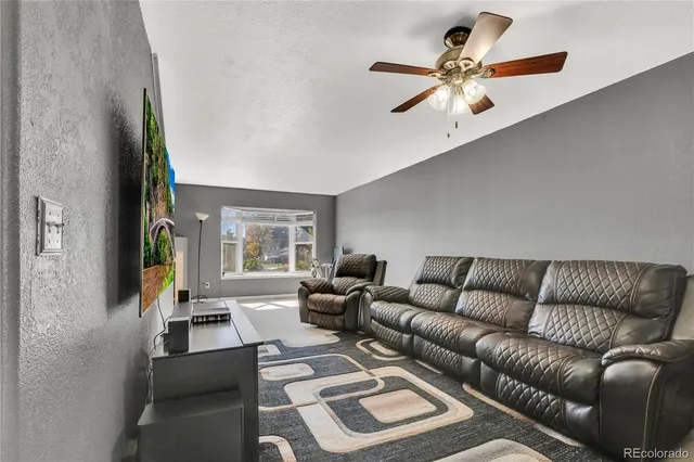 a living room with furniture and stairs