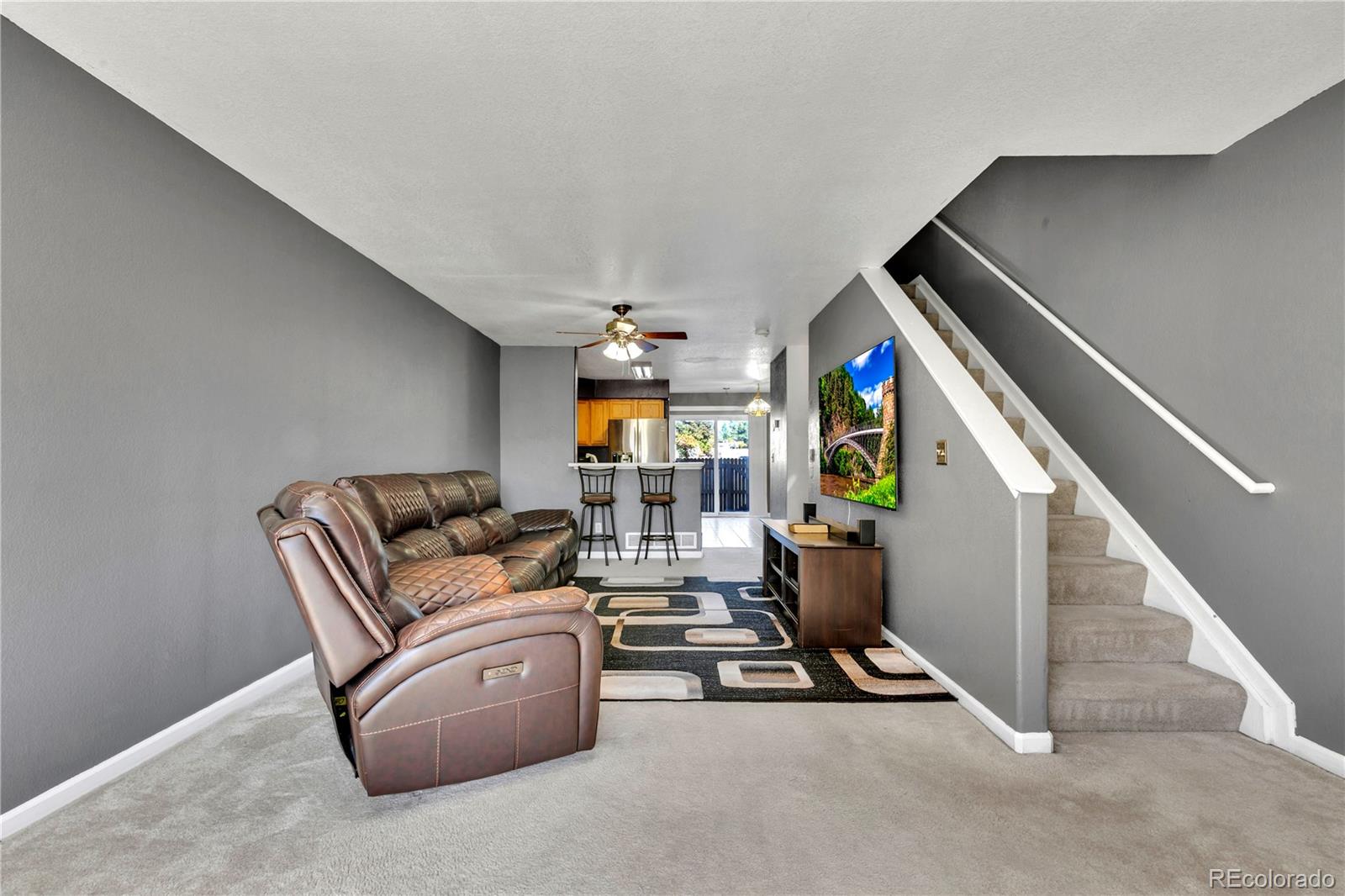 3300 West Florida Avenue, Unit 80 Denver, CO 80219 - Photo 8 of 24 a living room with furniture and stairs
