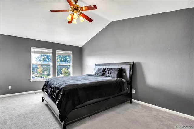 a bedroom with a bed and a night stand