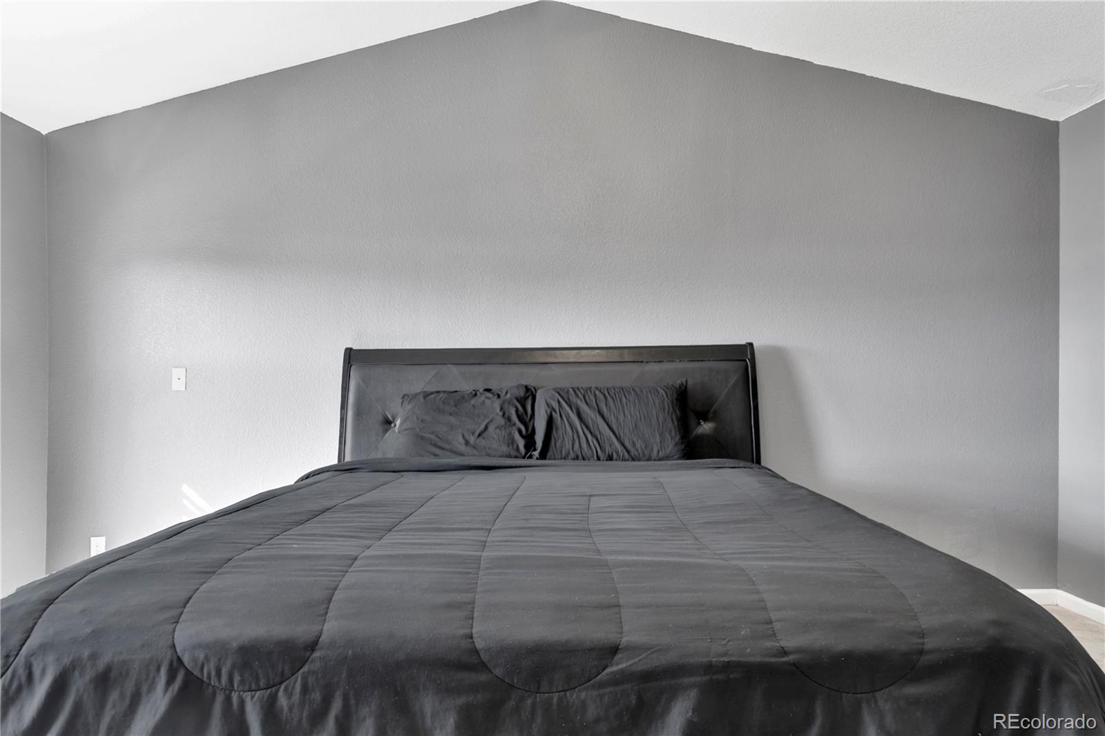 3300 West Florida Avenue, Unit 80 Denver, CO 80219 - Photo 10 of 24 a bedroom with a bed and a night stand