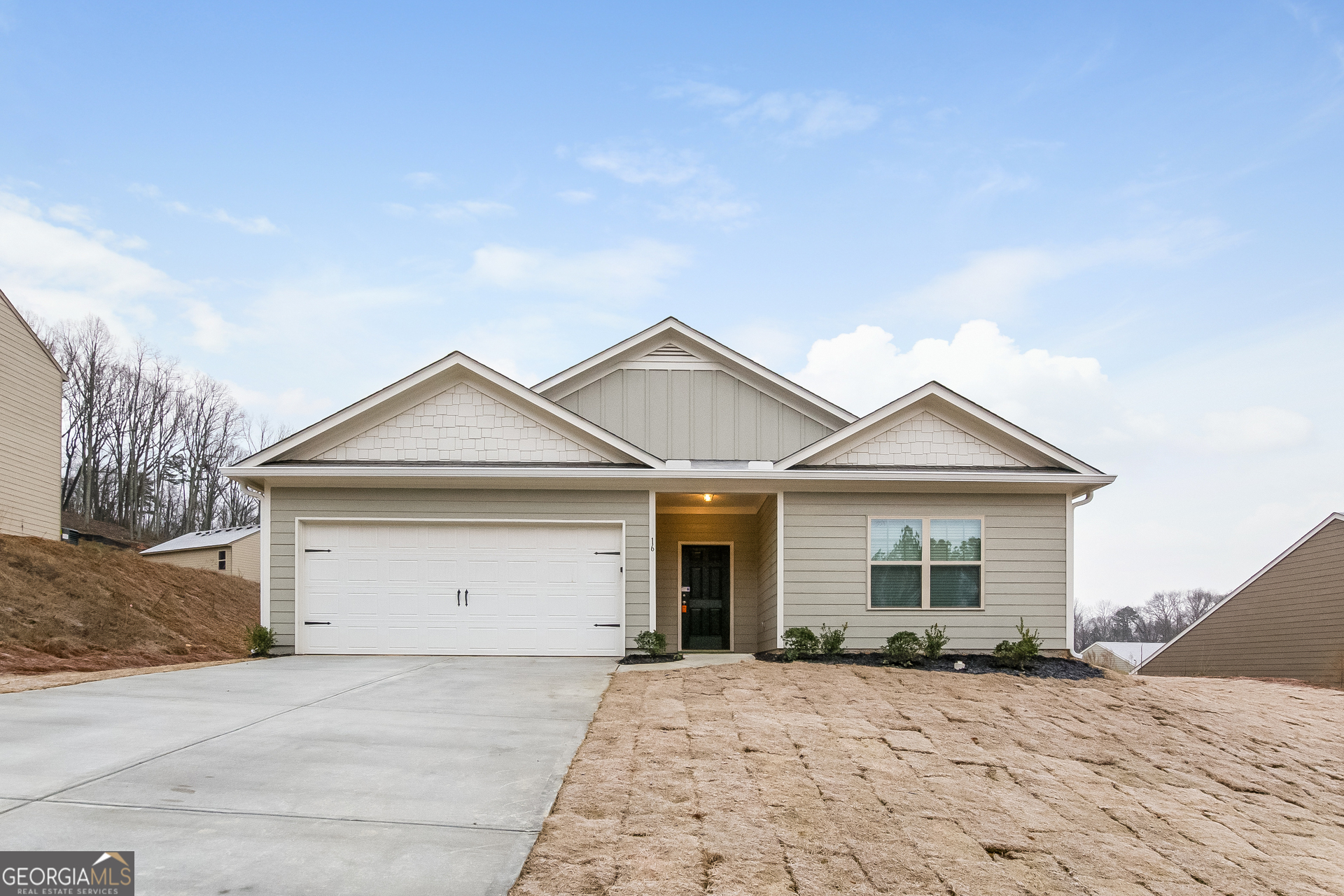 a view of a house with a yard and garage