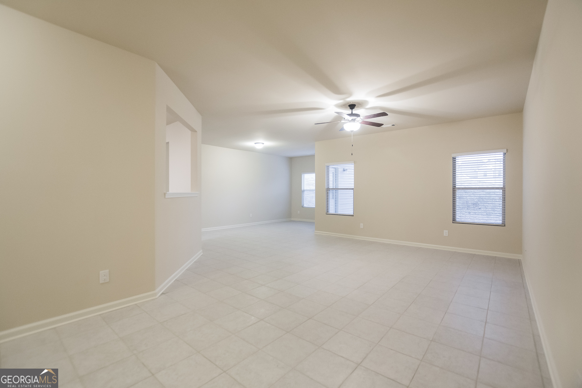 16 Sycamore Street Cartersville, GA 30120 - Photo 3 of 15 an empty room with windows and fan