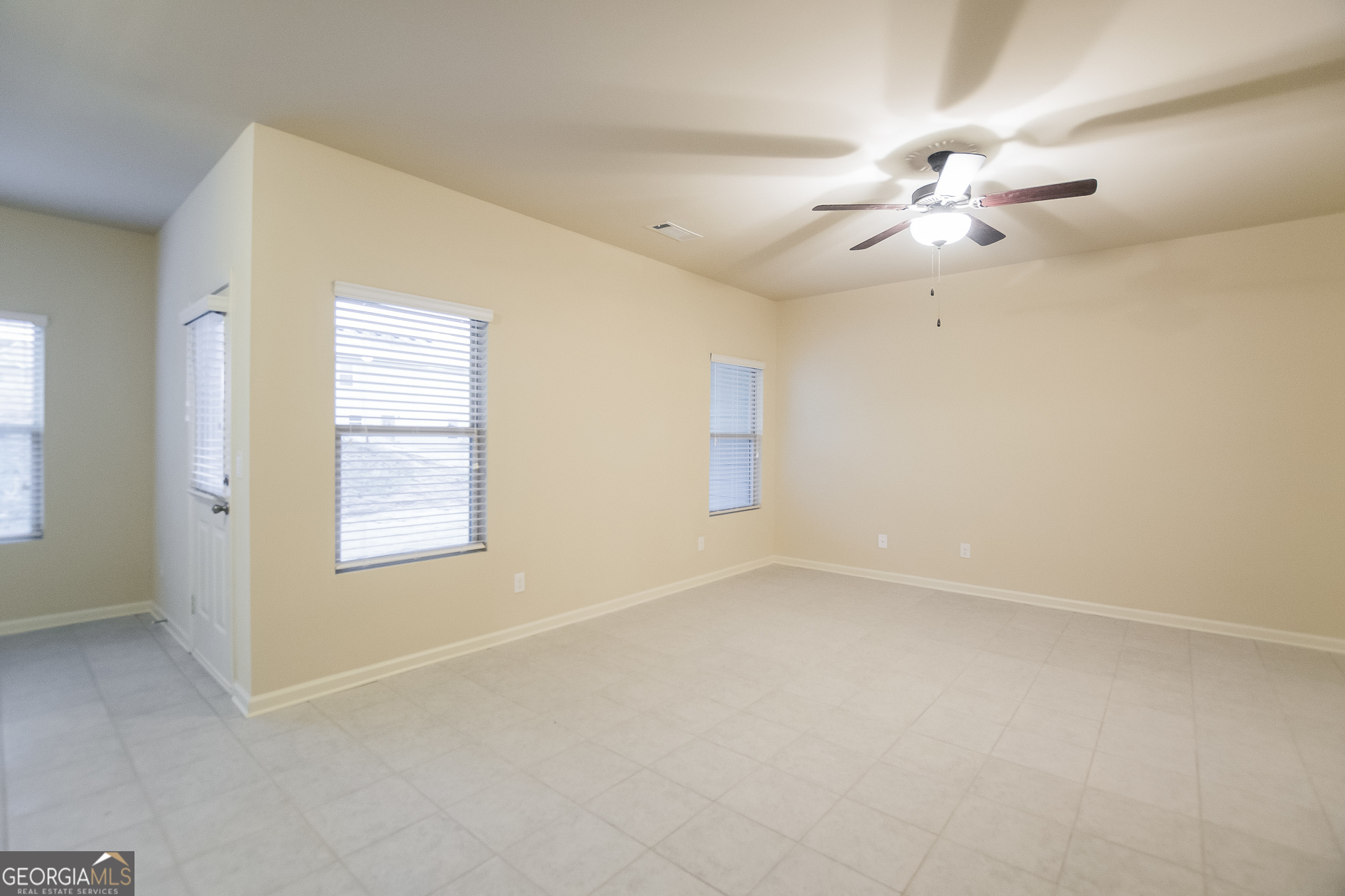 16 Sycamore Street Cartersville, GA 30120 - Photo 4 of 15 an empty room with windows and fan