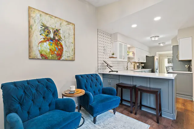 a living room with furniture and kitchen view