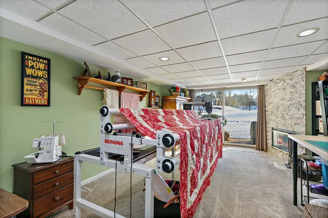 a living room with furniture a flat screen tv and a large window