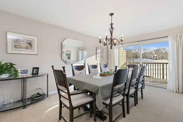 a view of a dining room with furniture and chandelier