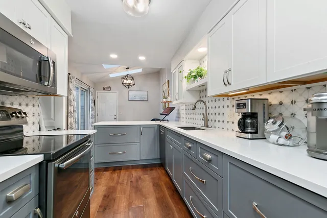 a kitchen with a sink stove and microwave
