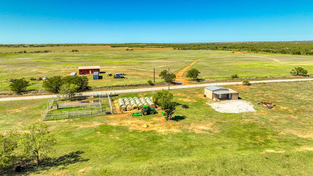 2337 Walsh Road Olney, TX 76374 - Photo 15 of 38 Expansive rural property featuring a red barn, a metal outbuilding, and a fenced enclosure