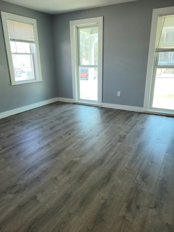 136 Commonwealth Road Wayland, MA 01778 - Photo 13 of 27 an empty room with wooden floor and windows