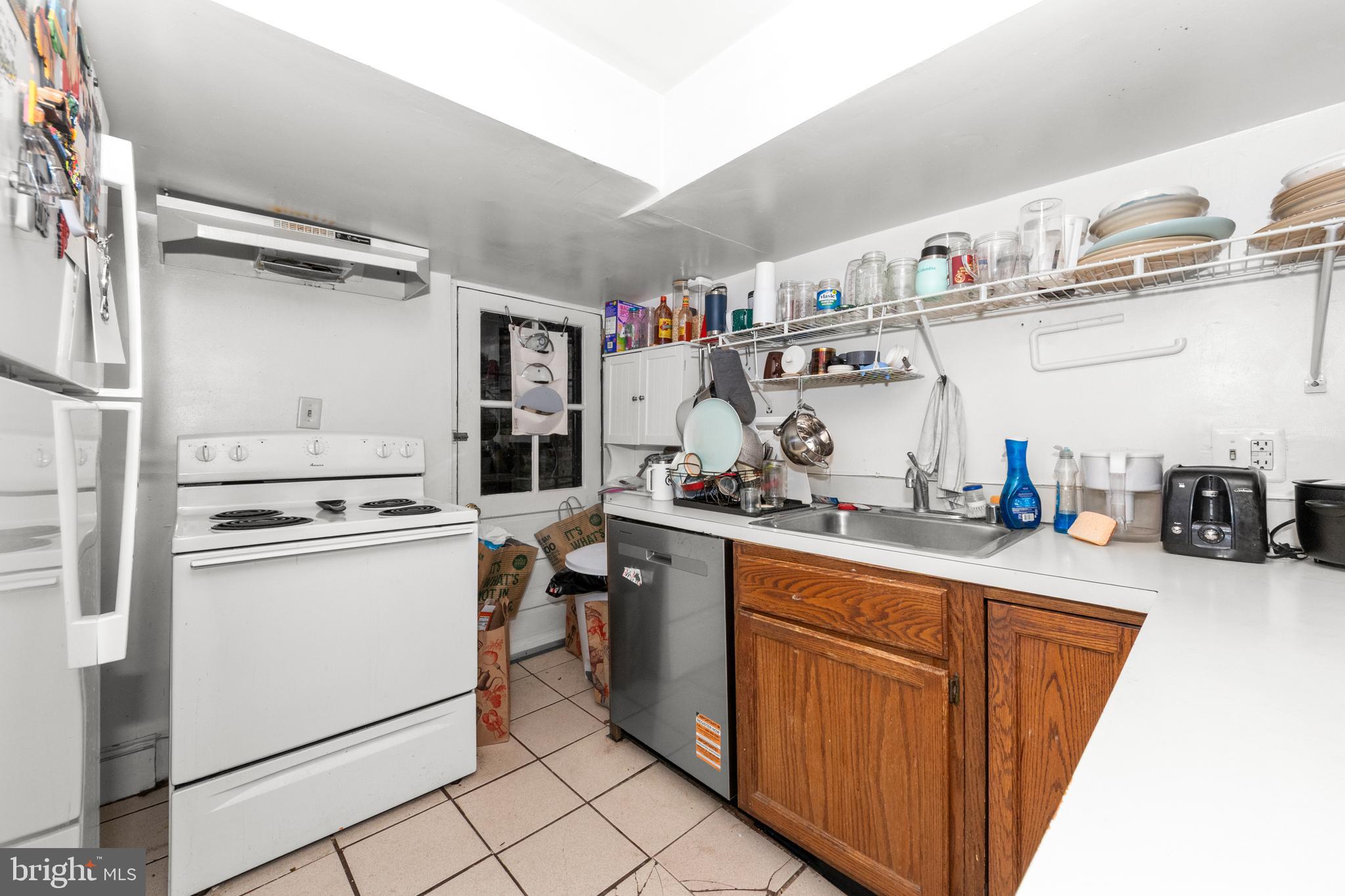 1013 Independence Avenue Southeast Washington, DC 20003 - Photo 14 of 35 a kitchen with stainless steel appliances granite countertop a sink and wooden cabinets