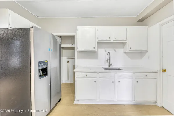 a kitchen with stainless steel appliances a refrigerator and cabinets