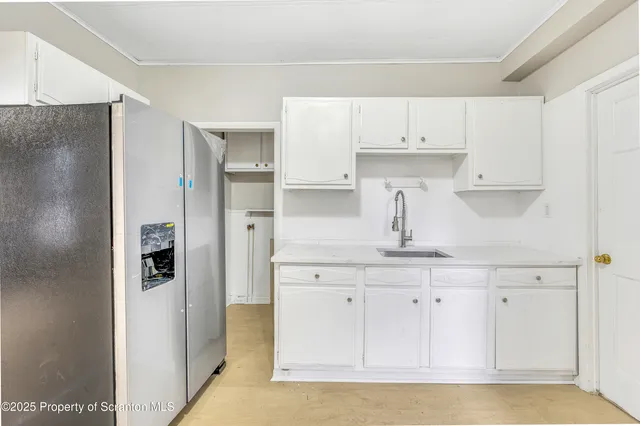 a kitchen with stainless steel appliances a refrigerator and cabinets