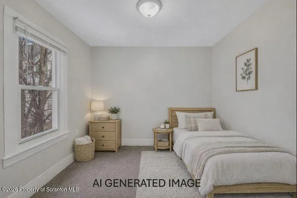 a bedroom with a bed and a lamp on dresser