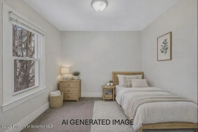 a bedroom with a bed and a lamp on dresser