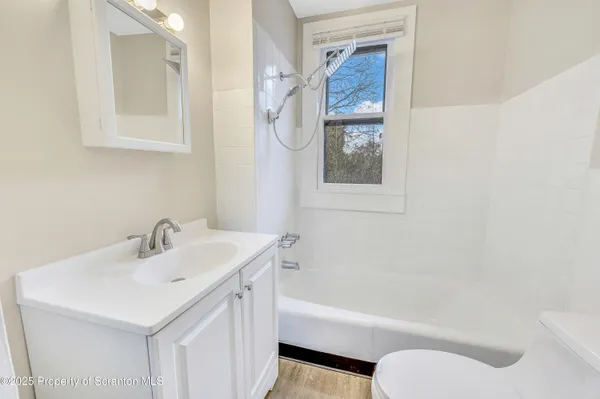 a bathroom with a sink a toilet and a bathtub