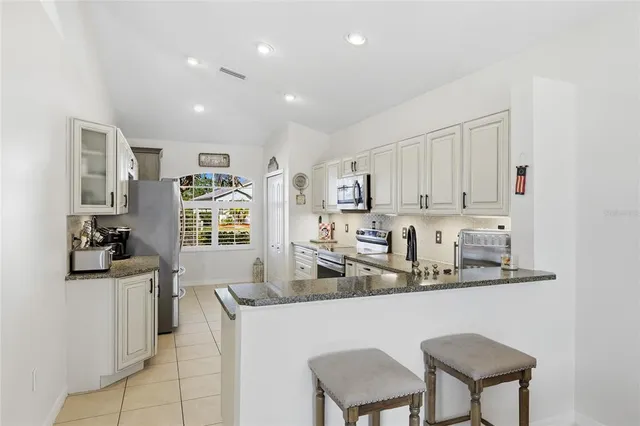 a bathroom with a toilet sink vanity and mirror