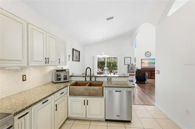 a bathroom with a granite countertop sink a toilet a mirror and bathtub