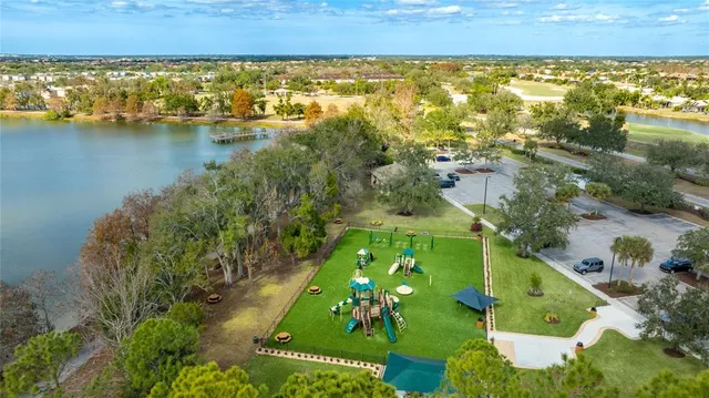 a view of a swimming pool with a patio and a yard