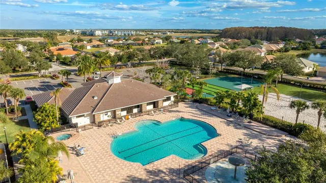 a living room with furniture a large window and a flat screen tv