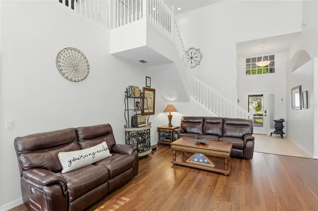 a room with stainless steel appliances kitchen island granite countertop a sink and cabinets