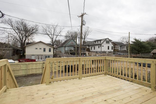 a view of a house with wooden deck