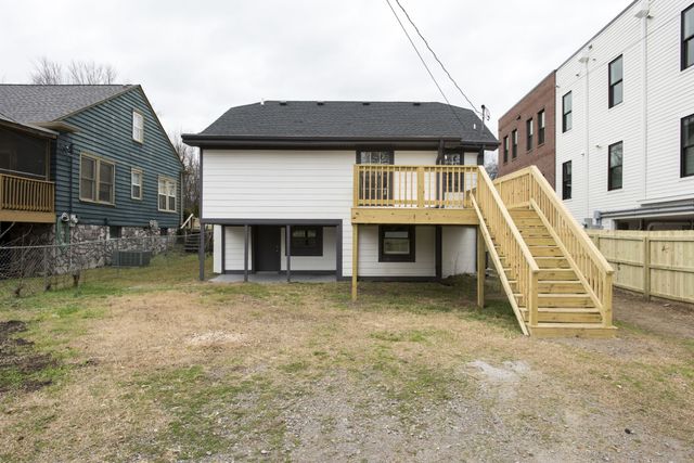 a front view of a building with a garden