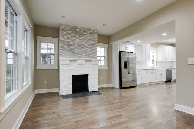 a view of a kitchen with a sink a refrigerator and window
