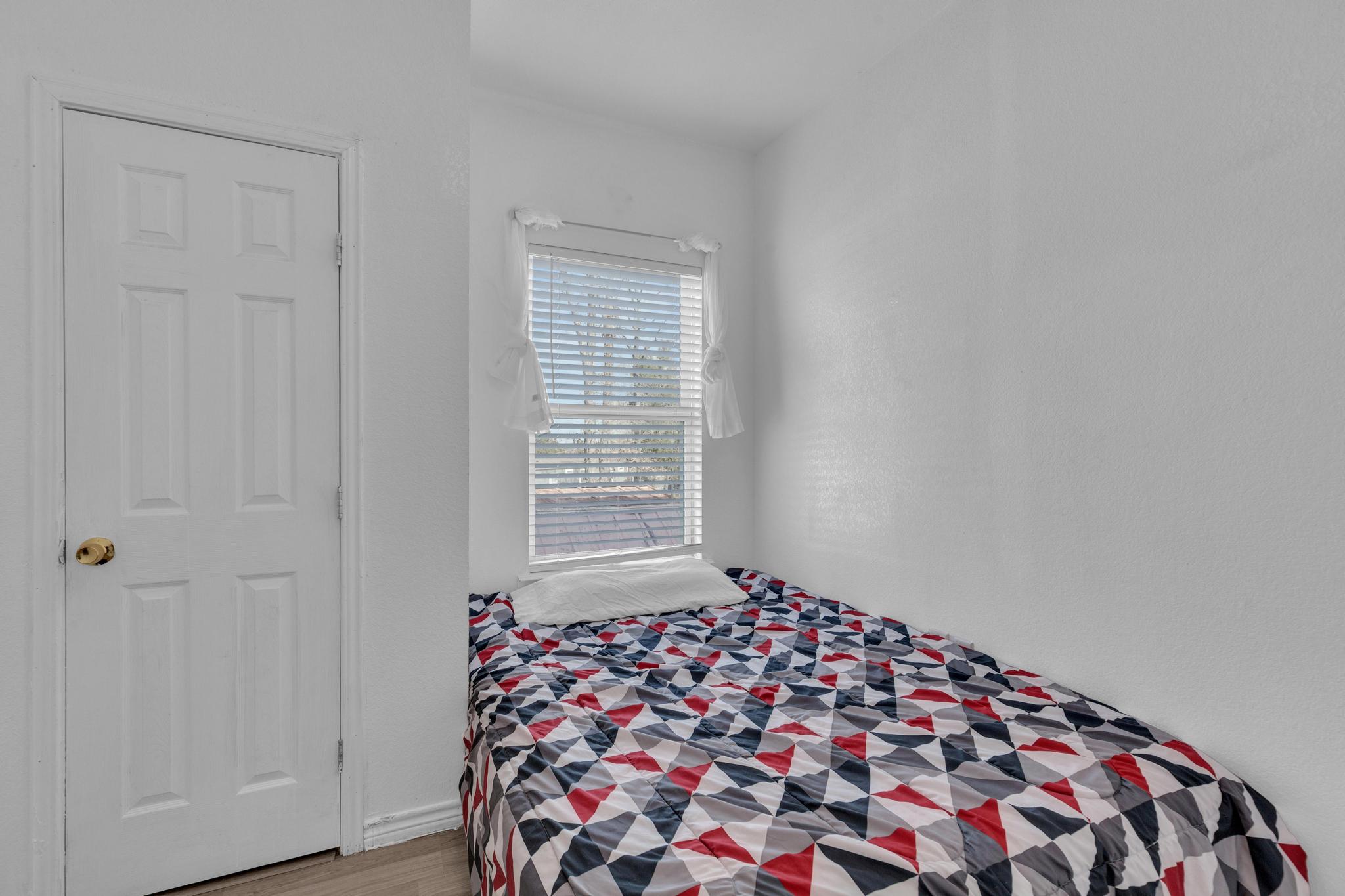 114 Crepe Myrtle Parkway Elgin, TX 78621 - Photo 24 of 40 a bedroom with a bed and a window