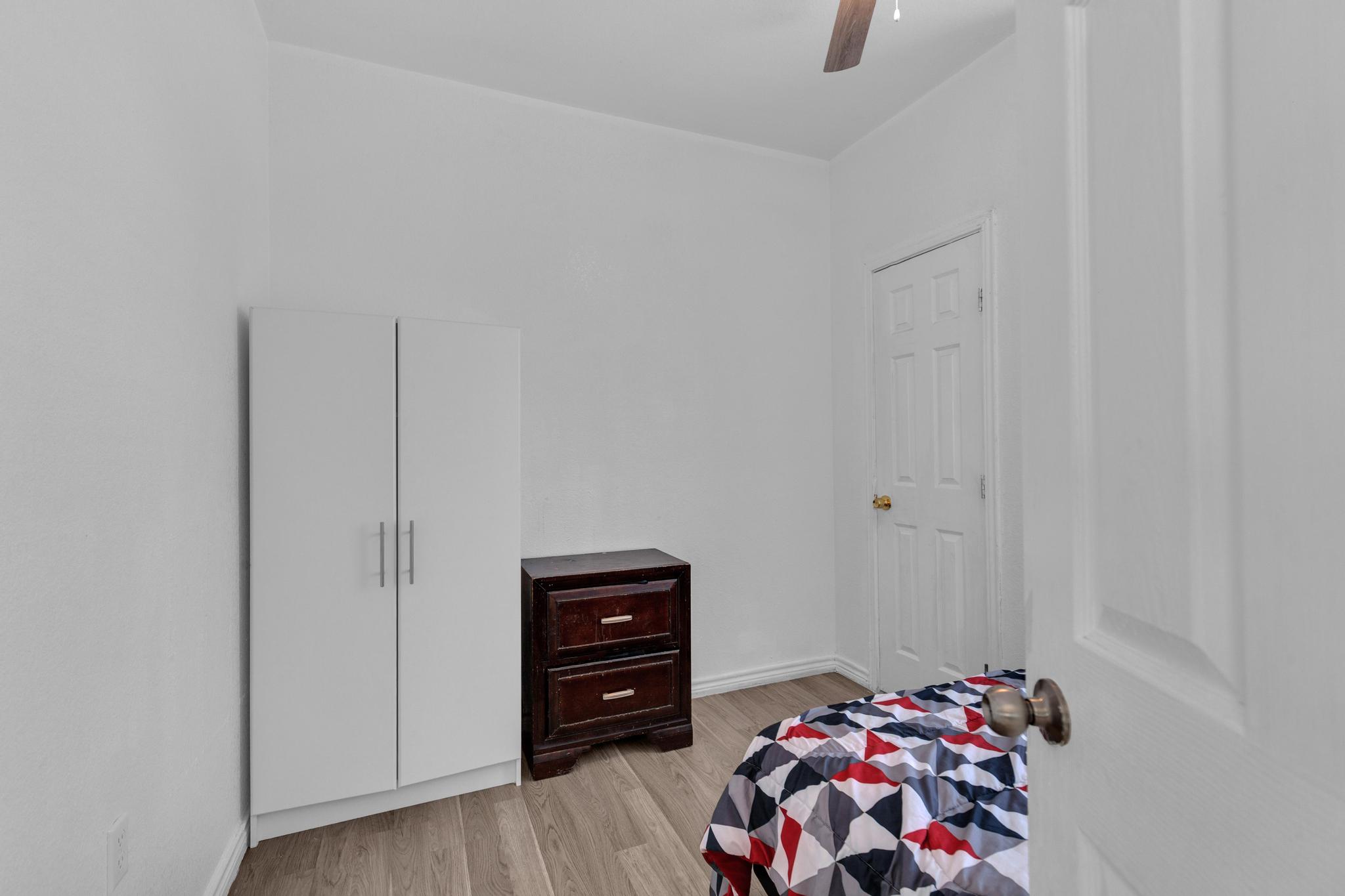 114 Crepe Myrtle Parkway Elgin, TX 78621 - Photo 25 of 40 a room with a walk in closet and wooden floor