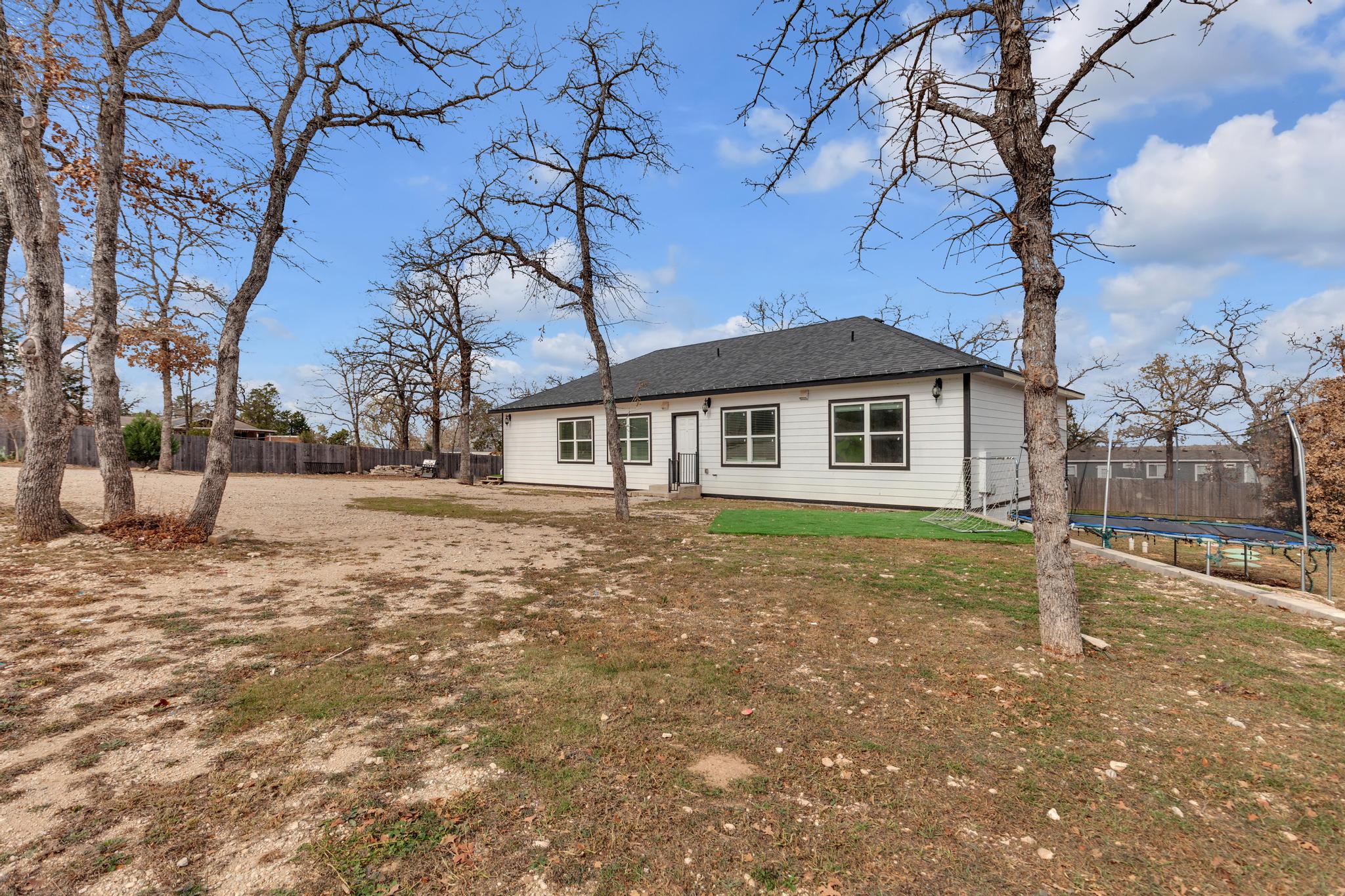 114 Crepe Myrtle Parkway Elgin, TX 78621 - Photo 32 of 40 a view of a house with a yard
