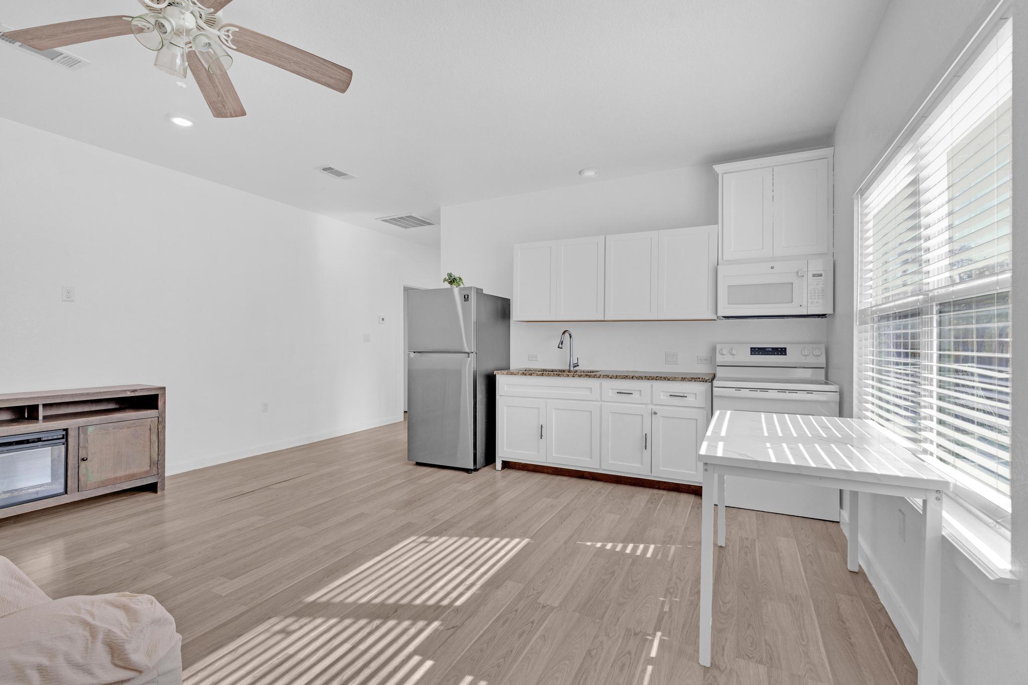 114 Crepe Myrtle Parkway Elgin, TX 78621 - Photo 4 of 40 a view of kitchen with furniture and wooden floor