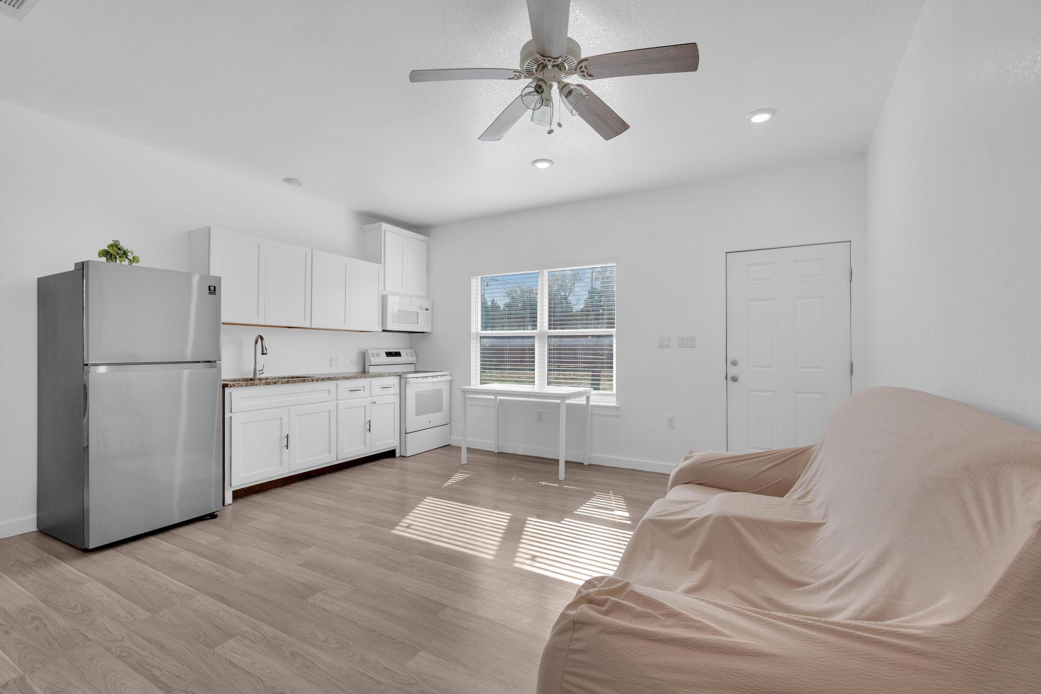 114 Crepe Myrtle Parkway Elgin, TX 78621 - Photo 5 of 40 a kitchen with a white cabinets and refrigerator