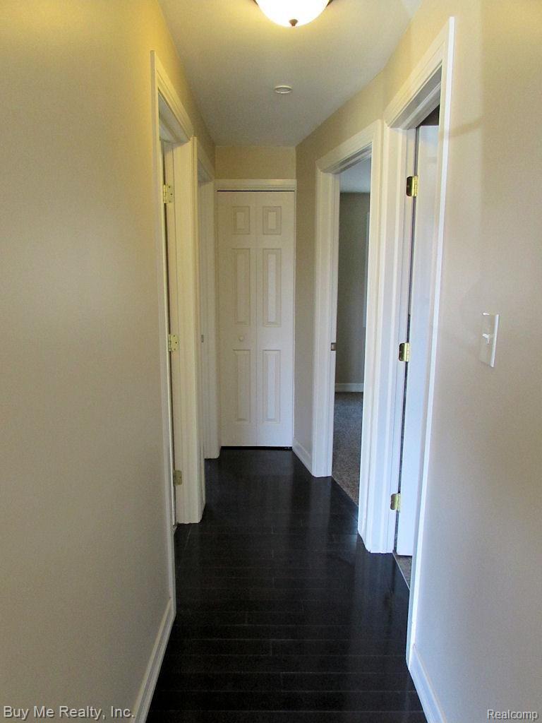 15814 Colbert Street Romulus, MI 48174 - Photo 11 of 21 Main hallway has hardwood flooring. New interior doors.