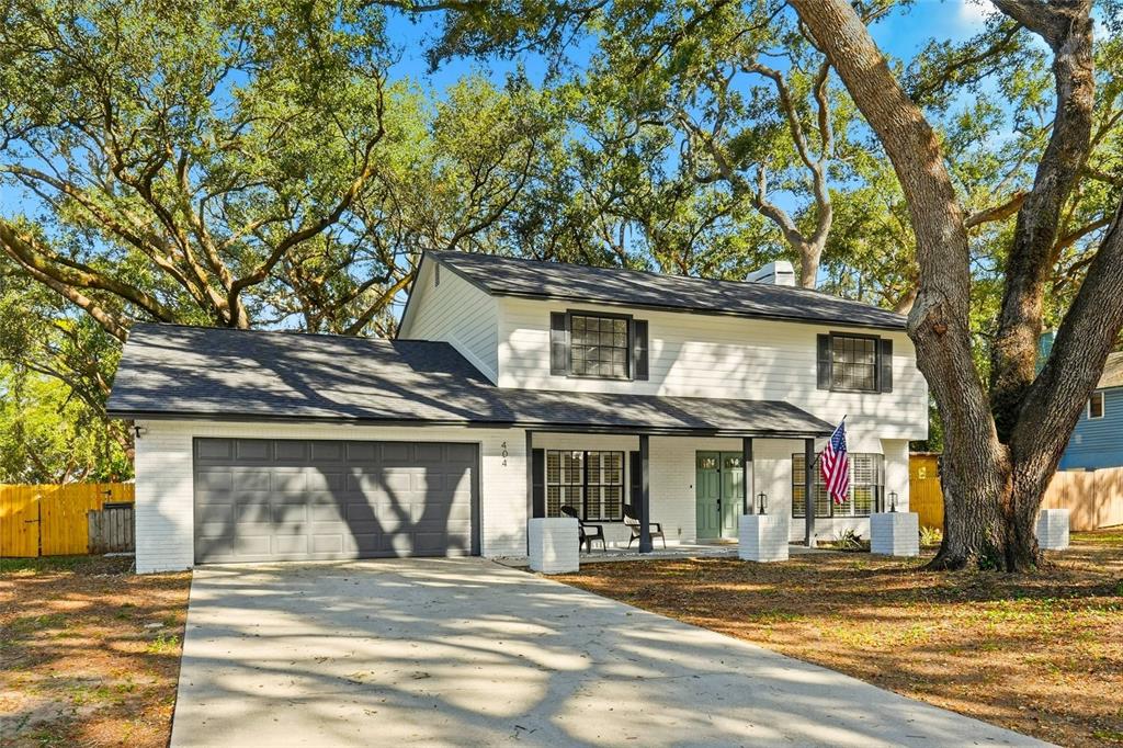 404 Bryan Oak Avenue Brandon, FL 33511 - Photo 1 of 43 a view of a brick house with large windows and a large tree