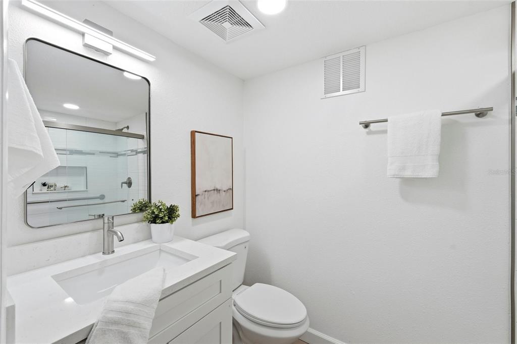 404 Bryan Oak Avenue Brandon, FL 33511 - Photo 24 of 43 a bathroom with a sink a toilet a mirror and vanity